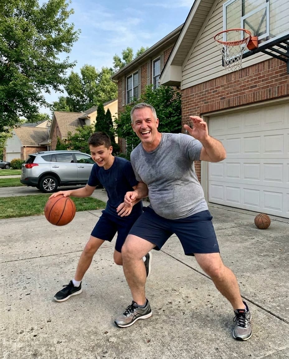 A man playing driveway basketball with his son